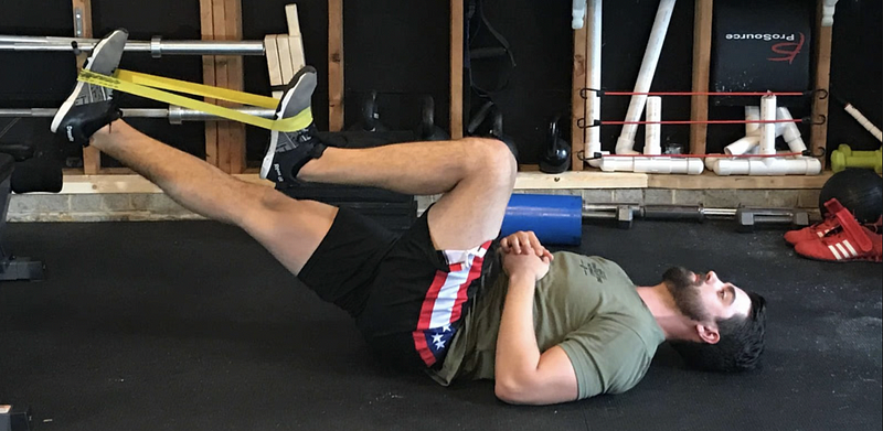 Demonstrating the lying psoas march for strength