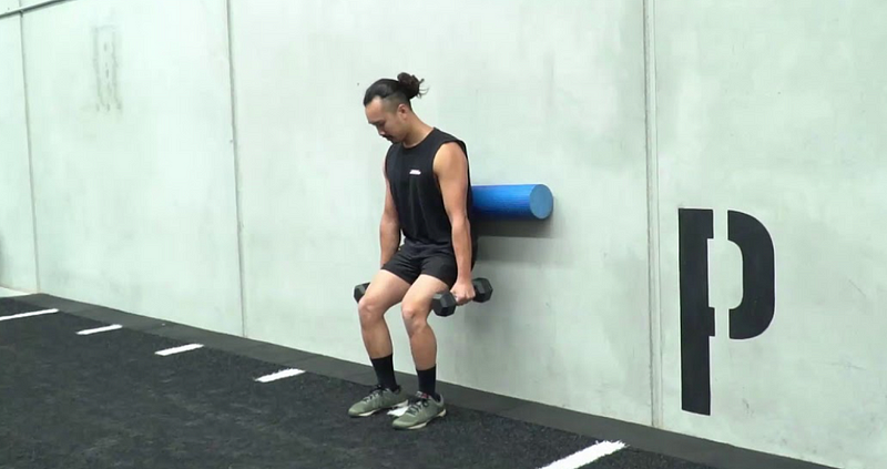 Wall-assisted squat exercise